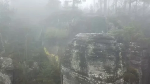 Flight up tilting down near the rocks in the fog Stock Footage 115603000