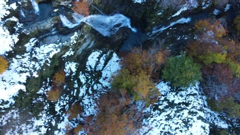 Flight with top view over waterfall with trees in autumn leaves Stock Footage 166199696