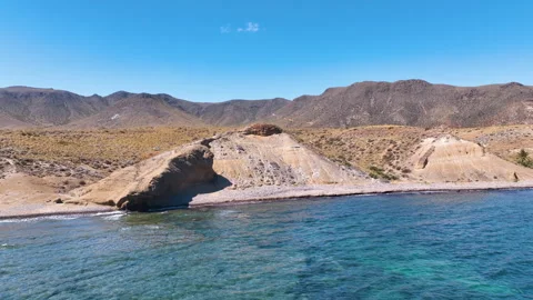 Flight towards closeup of iconic Cabo de Gata National Park foreshore geology Stockbeeldmateriaal 331275193