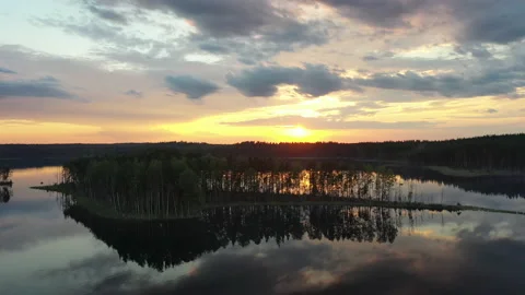 Flight towards the sunset over the lakes, island and forest. Stock Footage 146874508