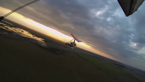 Flight of two hang gliders flying next to each other at sunset Stock Footage 197406364