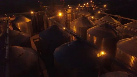 Flight under granaries and elevators or oil storage at night Video stock 78991433