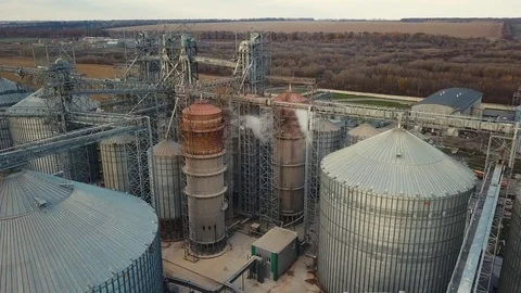 Flight under granaries and elevators or oil storage on autumn background Stock Footage 81595485