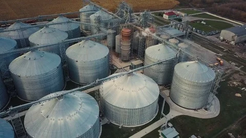Flight under granaries and elevators or oil storage on autumn background Stock Footage 81595578