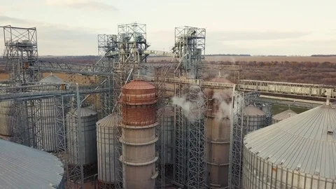 Flight under granaries and elevators or oil storage on autumn background Stock Footage 81595617
