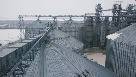 Flight under granaries and elevators or oil storage on winter background Stock Footage 88802447