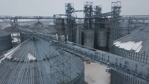 Flight under granaries and elevators or oil storage on winter background Stock Footage 88802749