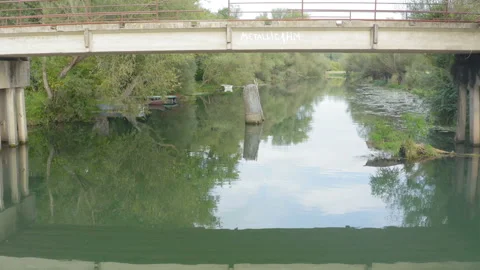 Flight under a rural bridge on a river Stock Footage 138532217