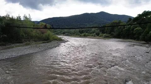 Flight under small river bridge in mountains Stock Footage 262280205
