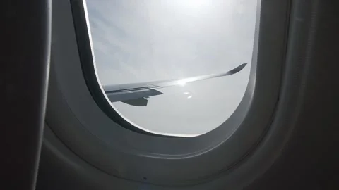 In-flight view: beautiful blue sky and sunlit scenery outside. Stock Footage 335735575
