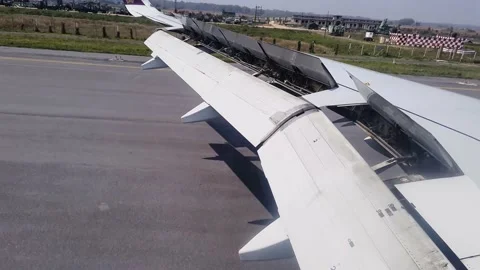 Flight window view of landing on runway at day Stock Footage 203946040