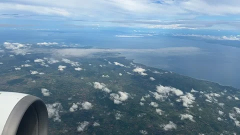 Flight window view over Philippines Pacific Ocean Cebu island Southeast Asia Stock Footage 341850125