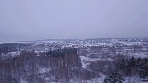 Flight in winter on the drone above the forest and the village Stock Footage 102178220