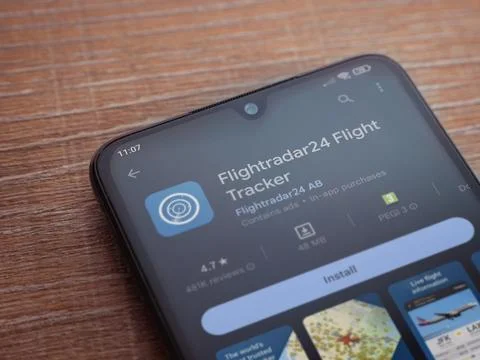 Flightradar24 Flight Tracker app play store page on smartphone on wooden ba.. Stock Photos