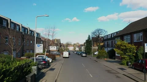 FLING BACKWARDS TRACKING A MOVING VAN IN QUIET RESIDENCIAL AREA Video stock 149855132