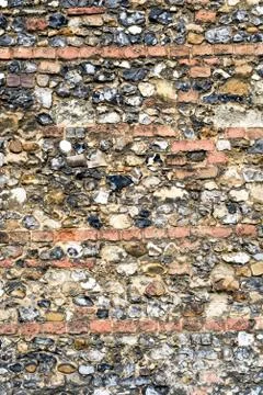 Flint stone wall texture from the aged exterior of a church building Stock Photos