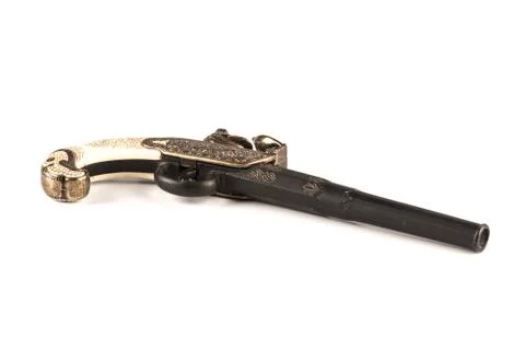 Flintlock pistol with engraved handle over a white background Stock Photos