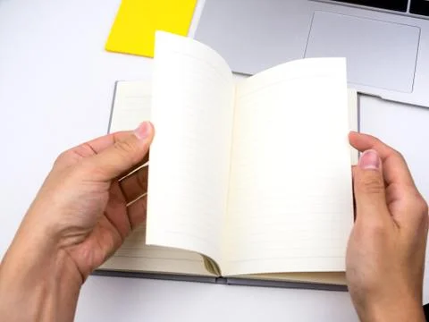 Flip and open notebook on desk Stock Photos