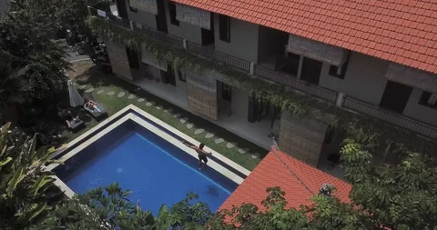Flip From Bali Balcony into Pool Stock Footage 106787356