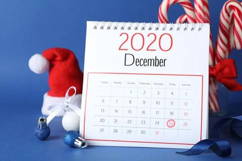 Flip calendar and Christmas decor on blue background. Holiday countdown Stock Photos