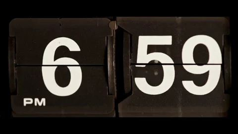Flip clock changes from six fifty nine to seven Stock Footage 329666915