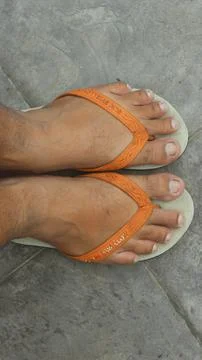 Flip-flops are used on both feet on the floor Stock Photos