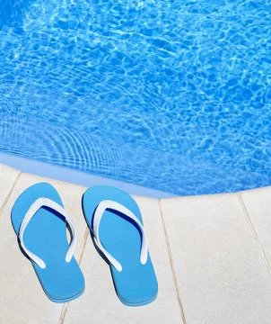 Flip flops on the background of the pool. Stock Photos