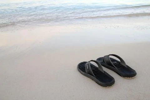 Flip-flops on the beach Stock Photos