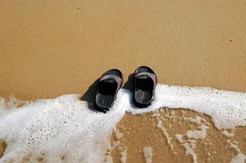 Flip-flops on the beach Stock Photos