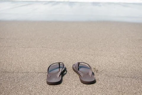 Flip flops on beach Stock Photos