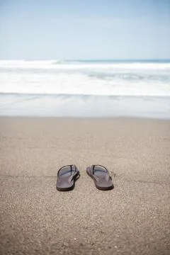 Flip flops on beach Stock Photos