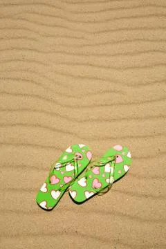 Flip flops on beach sand Stock Photos