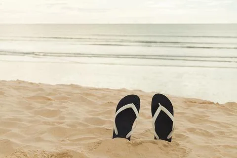 Flip flops on the beach sand. Vacation time and relax on the trip enjoying th Foto stock