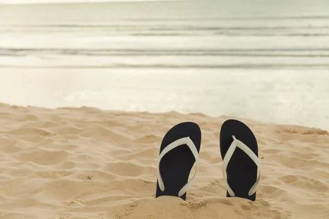 Flip flops on the beach sand. Vacation time and relax on the trip enjoying th Stock Photos