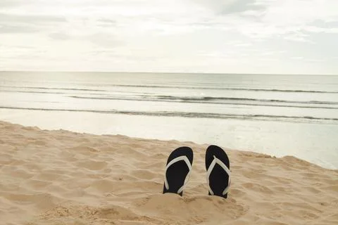 Flip flops on the beach sand. Vacation time and relax on the trip enjoying th Foto stock