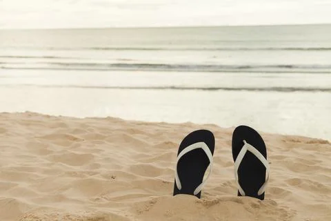 Flip flops on the beach sand. Vacation time and relax on the trip enjoying th Stock Photos