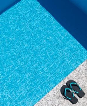 Flip flops on the edge of a pool Stock Photos