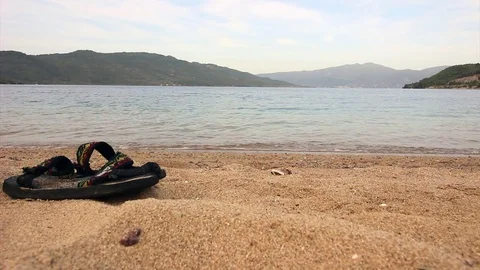 Flip flops on empty sandy beach before the sunset Stock Footage 81549506