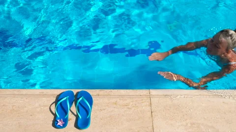 Flip flops with girl into pool. Stock Footage 225200353
