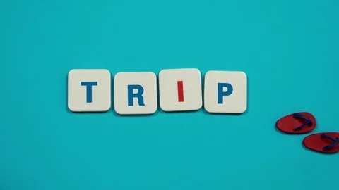 Flip flops moving over blue background with word trip. Stop motion Stock Footage 74249836
