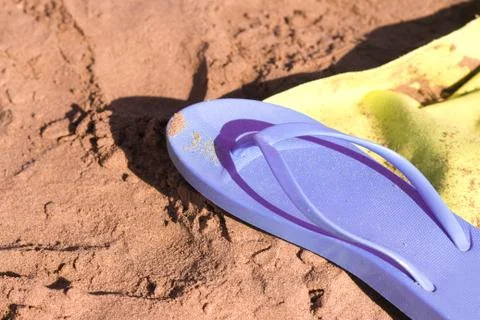 Flip flops on the sand of the beach Stock Photos