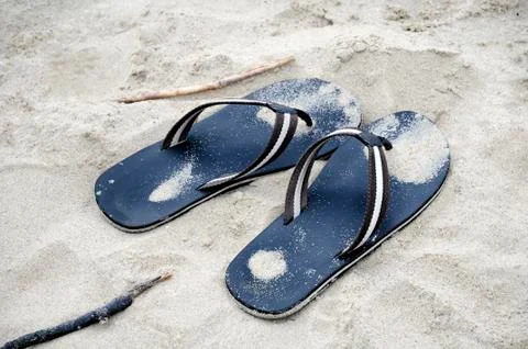 Flip flops in sand Stock Photos