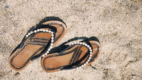 Flip flops on the sand. Stock Photos