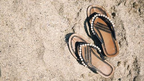 Flip flops on the sand. Stock Photos