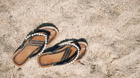 Flip flops on the sand. Stock Photos