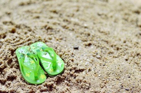 Flip flops on the sandy beach Stock Photos
