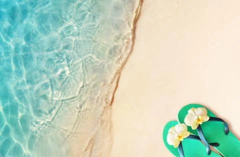 Flip flops on a sandy ocean beach Stock Photos