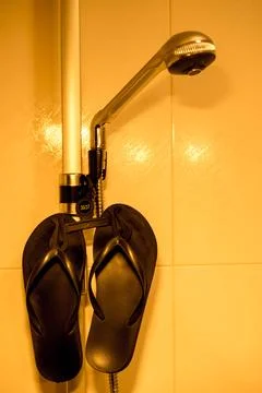 Flip-flops in the shower Stock Photos