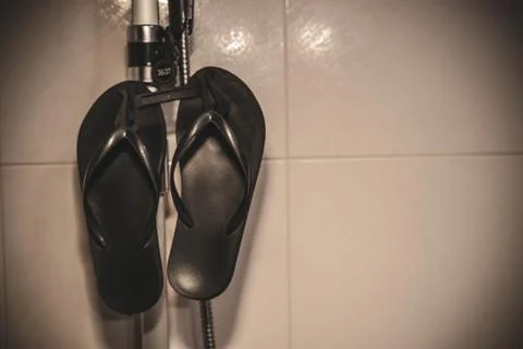 Flip-flops in the shower Stock Photos