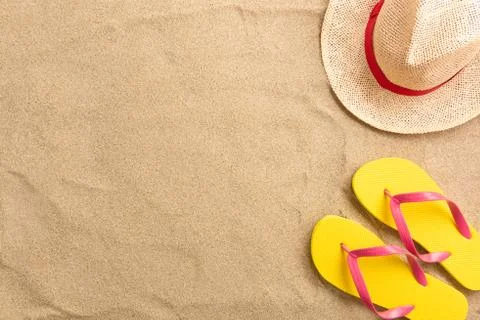 Flip flops, straw hat, on sand background. Beach vacation concept .Top view w Stock Photos